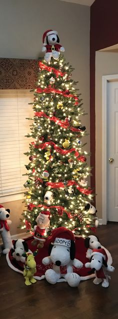 a christmas tree with stuffed animals around it