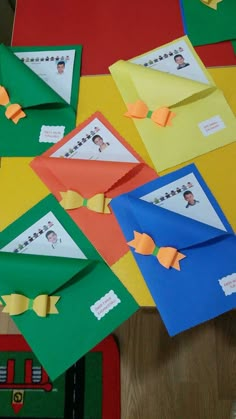 an assortment of different colored envelopes sitting on top of a table