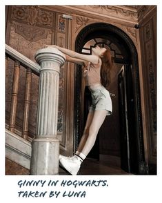 a woman standing on top of a stair case