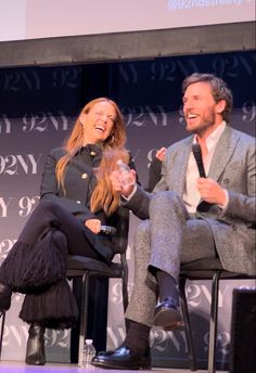 two people sitting on chairs talking to each other