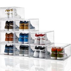 several pairs of shoes are stacked on top of each other in clear storage containers with lids