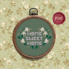 a cross stitch pattern with the words'home sweet home'in white and green