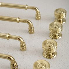 brass handles and knobs on a white surface