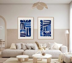 a living room with two paintings on the wall