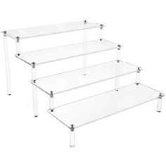 three clear glass shelves with metal legs