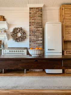 a kitchen with an old fashioned refrigerator and stove