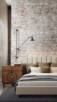 a bedroom with a brick wall and bed