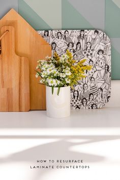 a cutting board with flowers in it next to a cutting board on a counter top