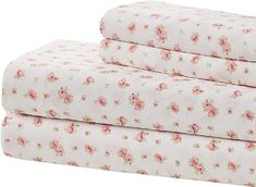 three sheets with pink flowers on them are folded up in front of each other,