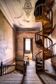 a spiral stair case in an old building