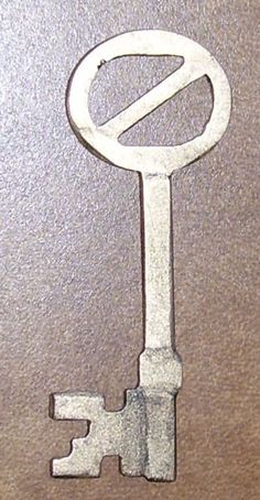 an old metal key with the letter o on it