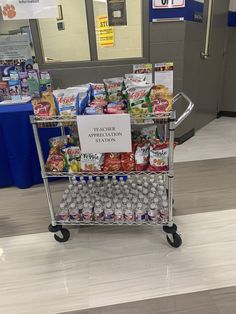 a shopping cart filled with lots of food on top of a hard wood floored floor