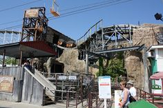 people are walking around in front of an amusement park