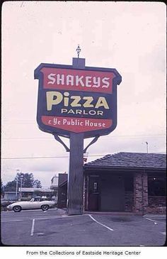 the sign for shakey's pizza parlor is in front of an empty parking lot