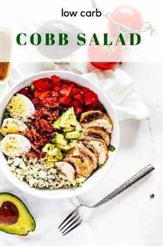 a bowl filled with meat, vegetables and avocado next to a glass of beer