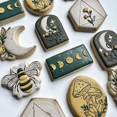 decorated cookies are arranged in the shape of hexagonals and moon, stars, and bees