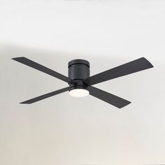 a black ceiling fan with two lights on it's sides and a white wall in the background