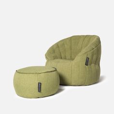 a green chair and ottoman sitting next to each other