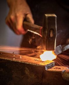 welder working on an object with sparks coming out of it and another person holding a knife