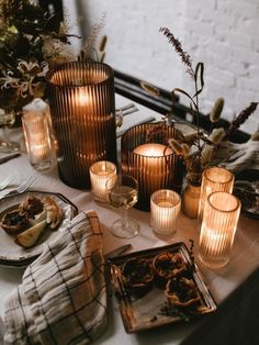 the table is set with candles and plates