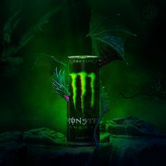 the monster energy drink is glowing green and it's in front of a dark background