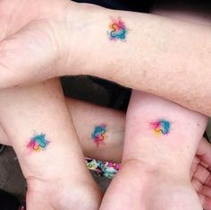 three people with matching tattoos on their arms