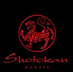 a red neon sign that reads shorokan karate on it's black background