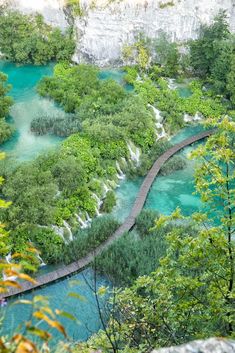 a wooden walkway leading to the blue lagoon in plitu national park, croatia