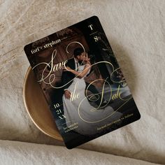 a save the date card sitting on top of a plate