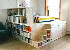 a room with bookshelves and a bed in it