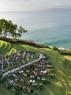 an aerial view of a wedding ceremony with the ocean in the background