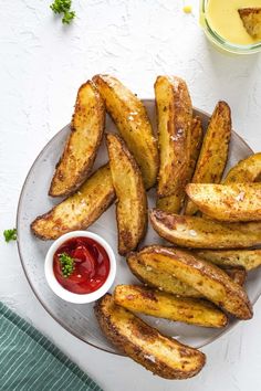 french fries on a plate with ketchup and mustard