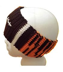 a white mannequin head wearing a brown and orange striped hat