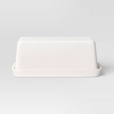 an empty white plate on a gray background