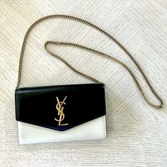 This Is A Gently Used Saint Laurent Uptown Wallet On Chain. This Is Crema / Nero With Gold Hardware. There Are Some Very Minor Marks (Pictured) But These Can Likely Be Buffed Away With A Cloth. This Is In Excellent Condition And Only Used A Couple Times. This Includes The Dust Bag, Box And Tissue. Does Not Include The Card Insert. Rare And Hard To Find. Wallet On Chain, Saint Laurent Bag, Red Gold, Gold Hardware, Saint Laurent, Dust Bag, Bag Lady, Wallet, Chain