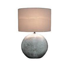 a table lamp with a white shade on it and a light in the shape of a flower