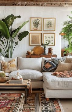 a living room filled with lots of furniture and plants on the wall above it's couch