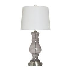 a silver lamp with a white shade on it