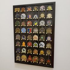 a display case with many different types of badges on it's sides and in the middle