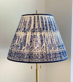 a blue and white lamp on a table