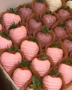 a box filled with lots of pink and white chocolate covered strawberries on top of each other