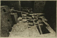 black and white photograph of an urban area with stairs leading up to the top floor