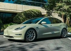 a silver car parked in front of a building