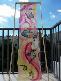 a painting on the side of a building with butterflies painted on it and an easel