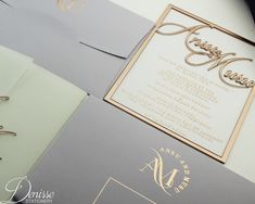 the wedding stationery is laid out on top of each other