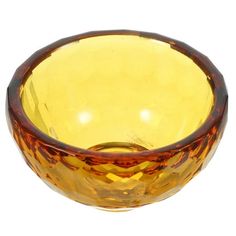 a yellow glass bowl sitting on top of a white table