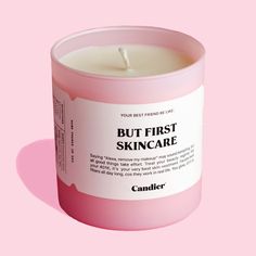 a pink candle with the words, but first skincare on it's label