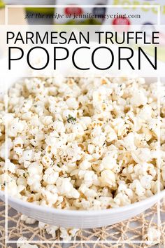 a white bowl filled with popcorn on top of a table