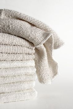 a stack of folded towels sitting on top of each other