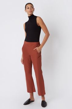 Fall calls for ease with our elastic waist Brit Crop Pant. With a mid-rise fit, angle seam pockets and the perfect leg opening, this style is a breeze to wear in the cooler weather. Pair it with your favorite ankle boot or sneaker, this style is designed for women on the go.THIS ITEM IS FINAL SALE. 1.5" front waistband, elastic at sides and back, angle seams with front pockets, midrise, easy fit, clean finish hem. - 51% Cotton, 49% Nylon - Fabric Woven in Italy - Made in NYC - Professional dry c Fitted Straight Pants With Pull-on Style, Casual Straight Leg Pull-on Dress Pants, Business Casual Straight Dress Pants With Pull-on Style, Casual Pull-on Straight Leg Dress Pants, Casual Straight Leg Dress Pants With Pull-on Style, Stretch Pants With Welt Pockets For Fall, Fall Business Casual Pants With Minimal Stretch, Business Casual Fall Pants With Minimal Stretch, Fall Stretch Dress Pants With Welt Pockets